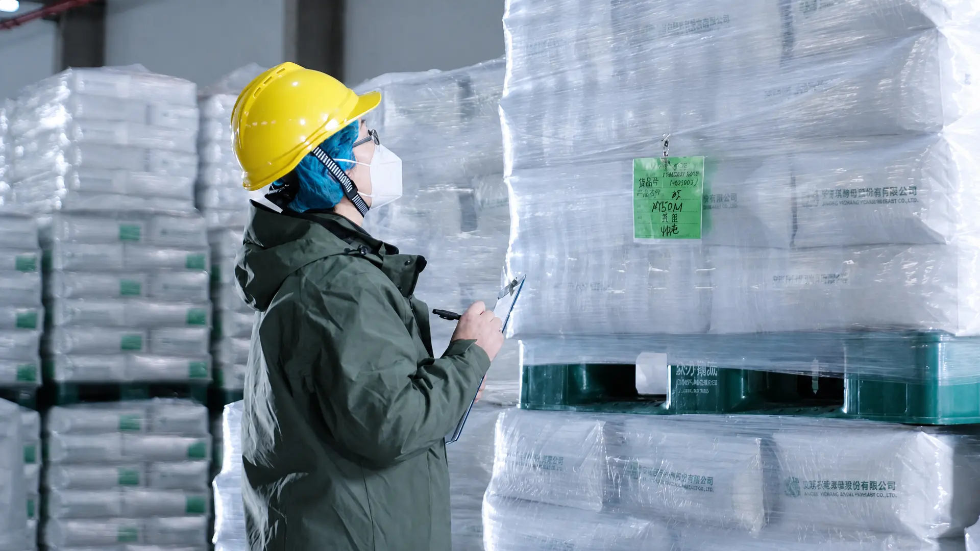 worker inspecting palletized modified starch products in warehouse